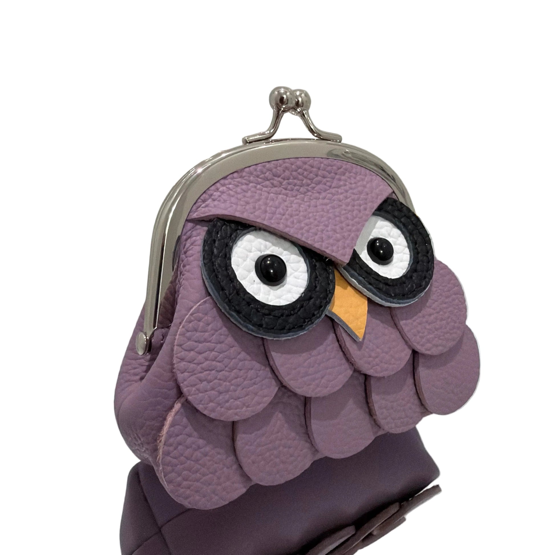 Purple owl-shaped coin purse on a white surface