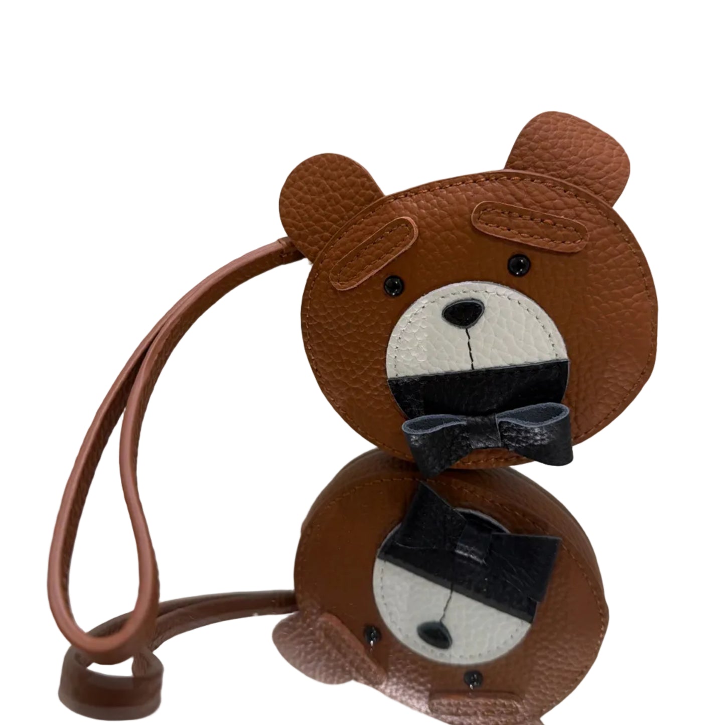 Brown monkey-shaped hair clips with black bows on a light background