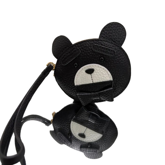 Black earbud covers with cartoon face design on a white background