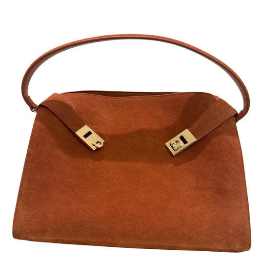 Brown leather handbag with gold hardware on a white background