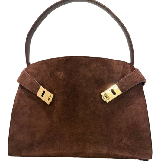 Brown suede handbag with gold hardware on a white background