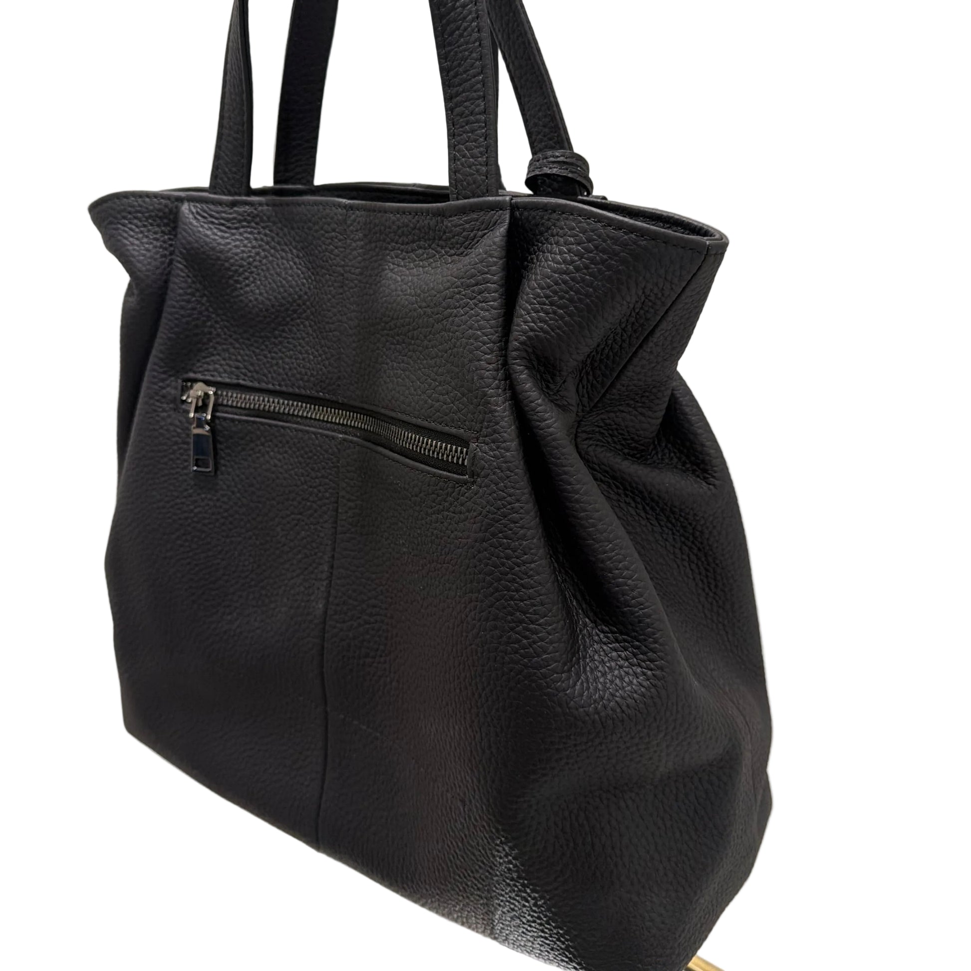Black leather backpack on a white surface with a neutral background