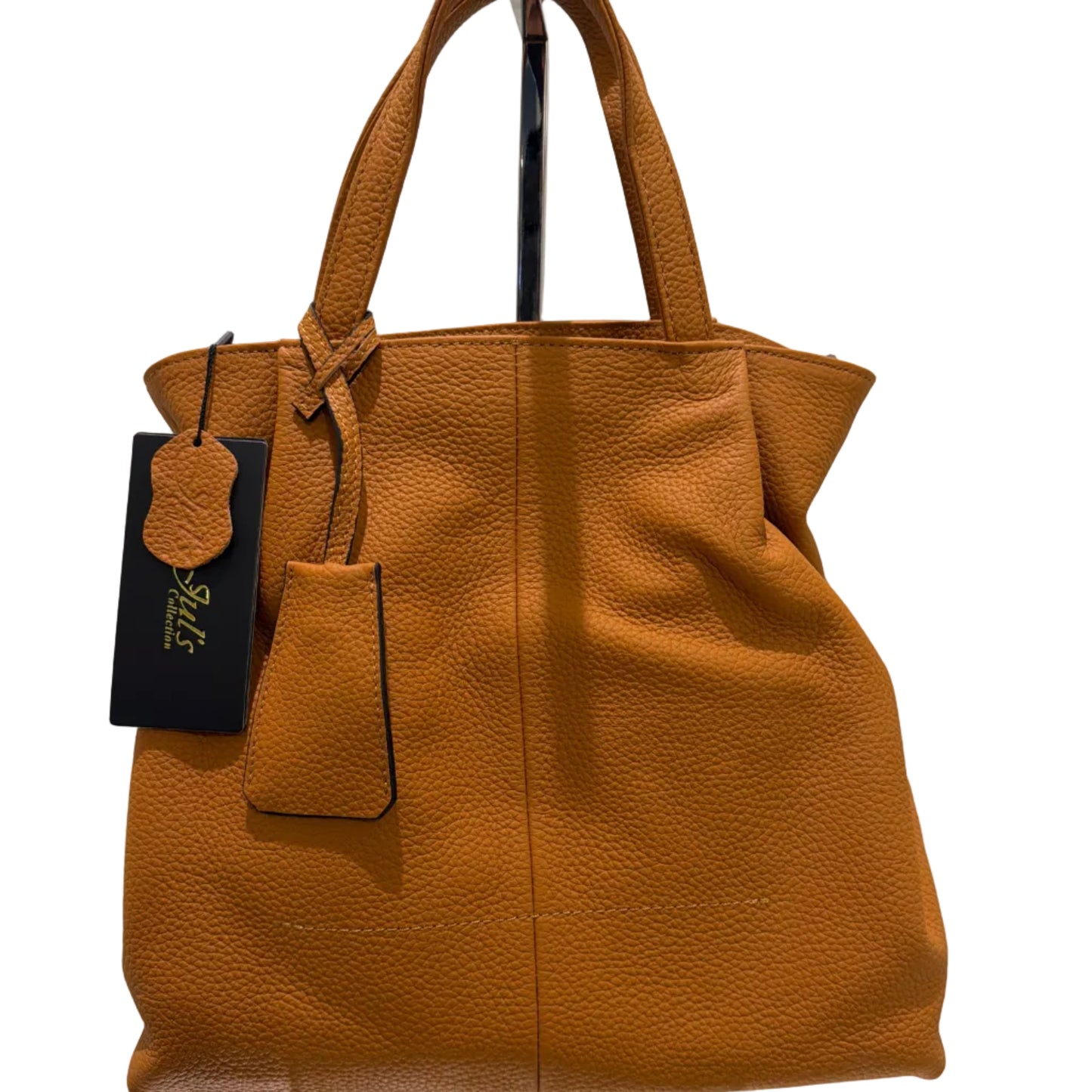 Brown leather handbag with a visible brand tag on a white background