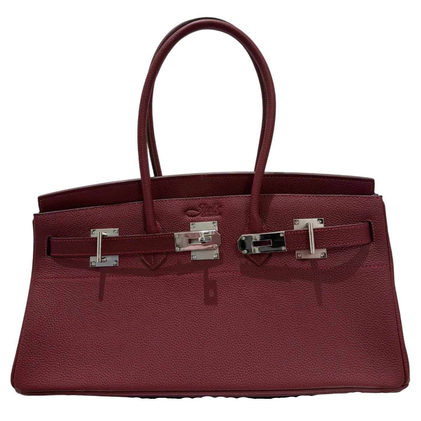 Burgundy handbag with silver hardware on a light gray background