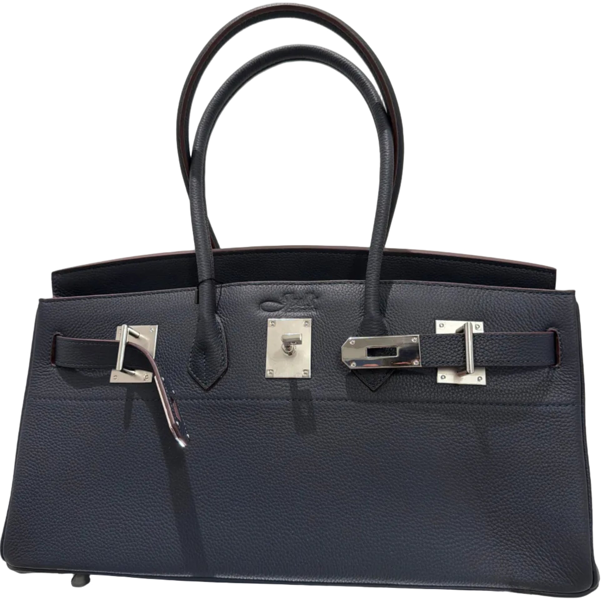 Black leather handbag with silver hardware on a light gray background