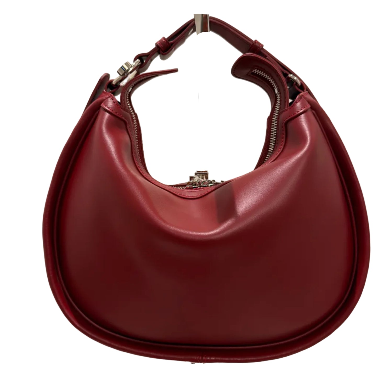 Maroon handbag with a gold handle on a light beige background