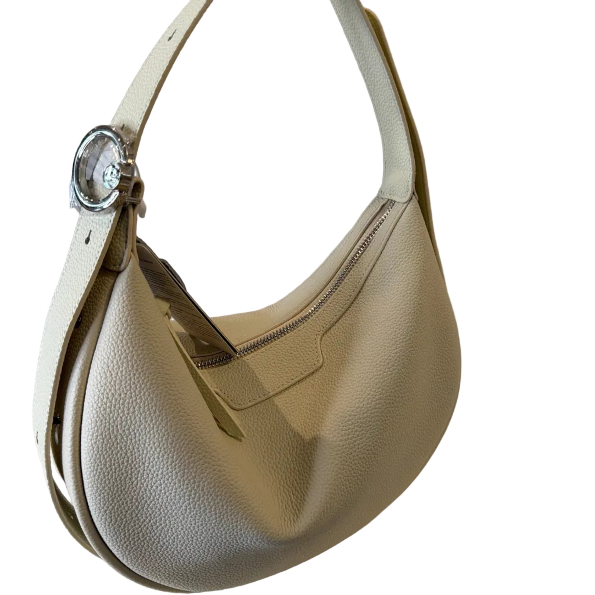 Gold handbag with a clear crystal charm on a neutral background