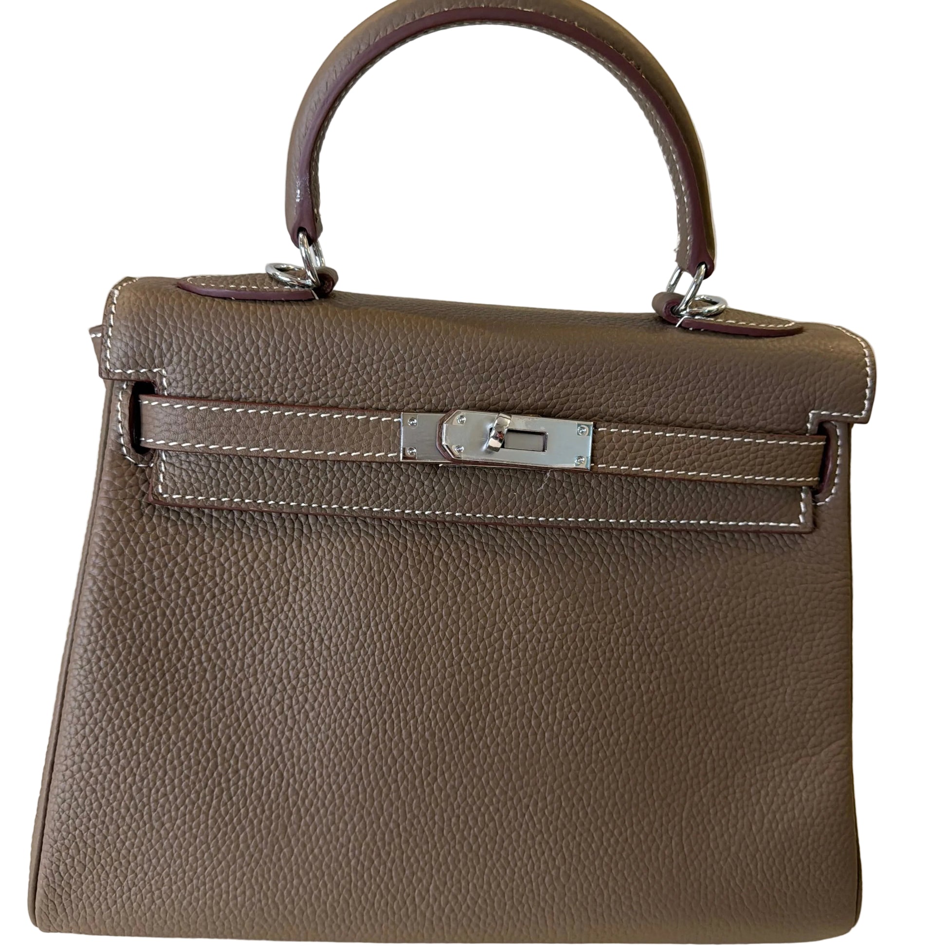 Brown leather handbag with a silver clasp on a light background