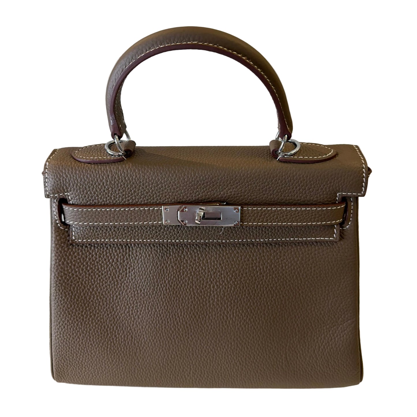 Brown leather handbag with a silver clasp on a white background