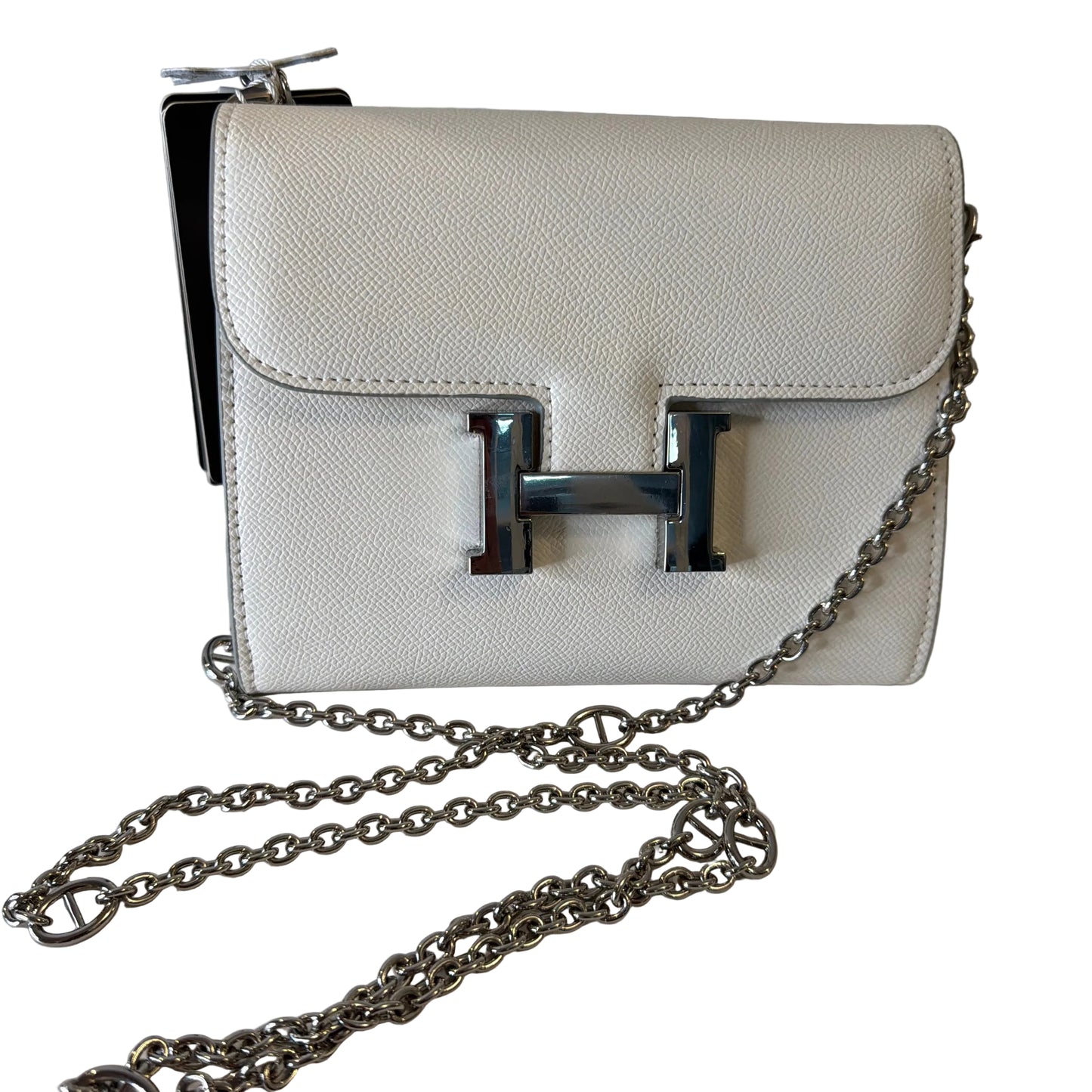 White handbag with a silver chain on a white background