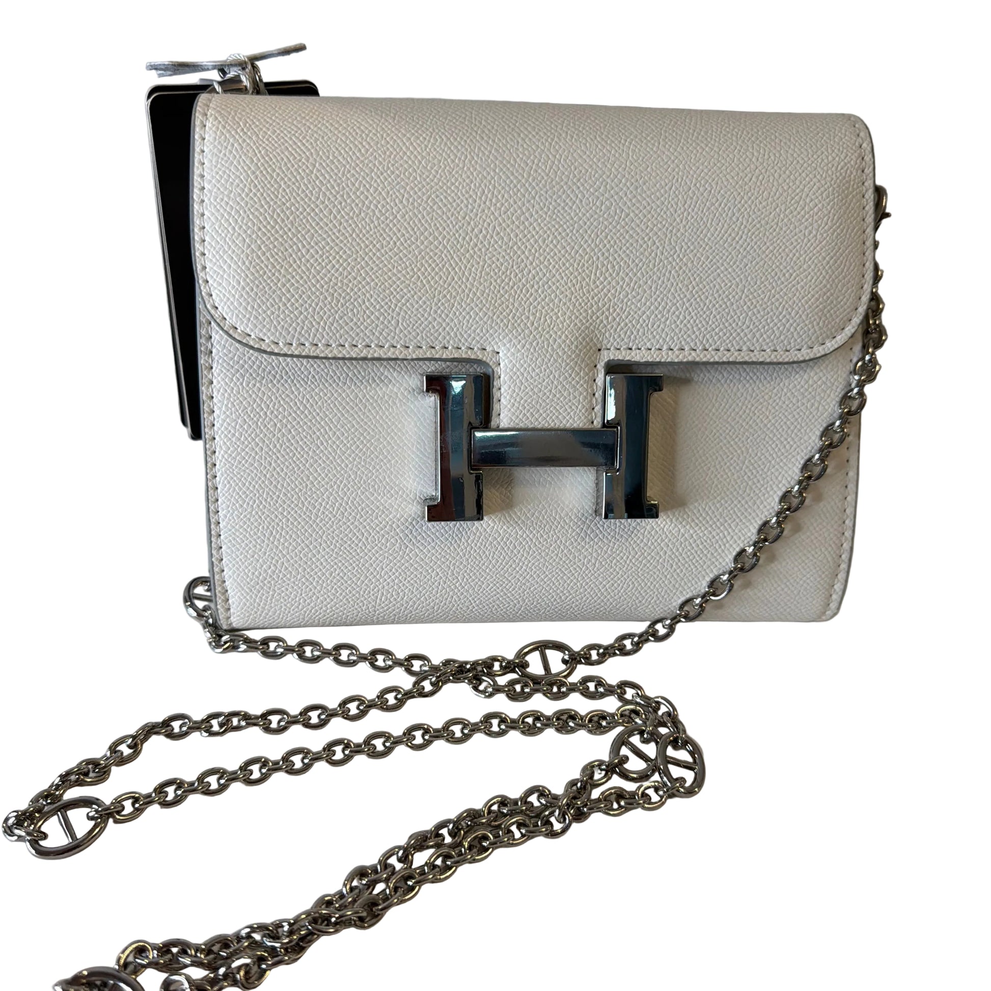 White handbag with a silver chain on a white background