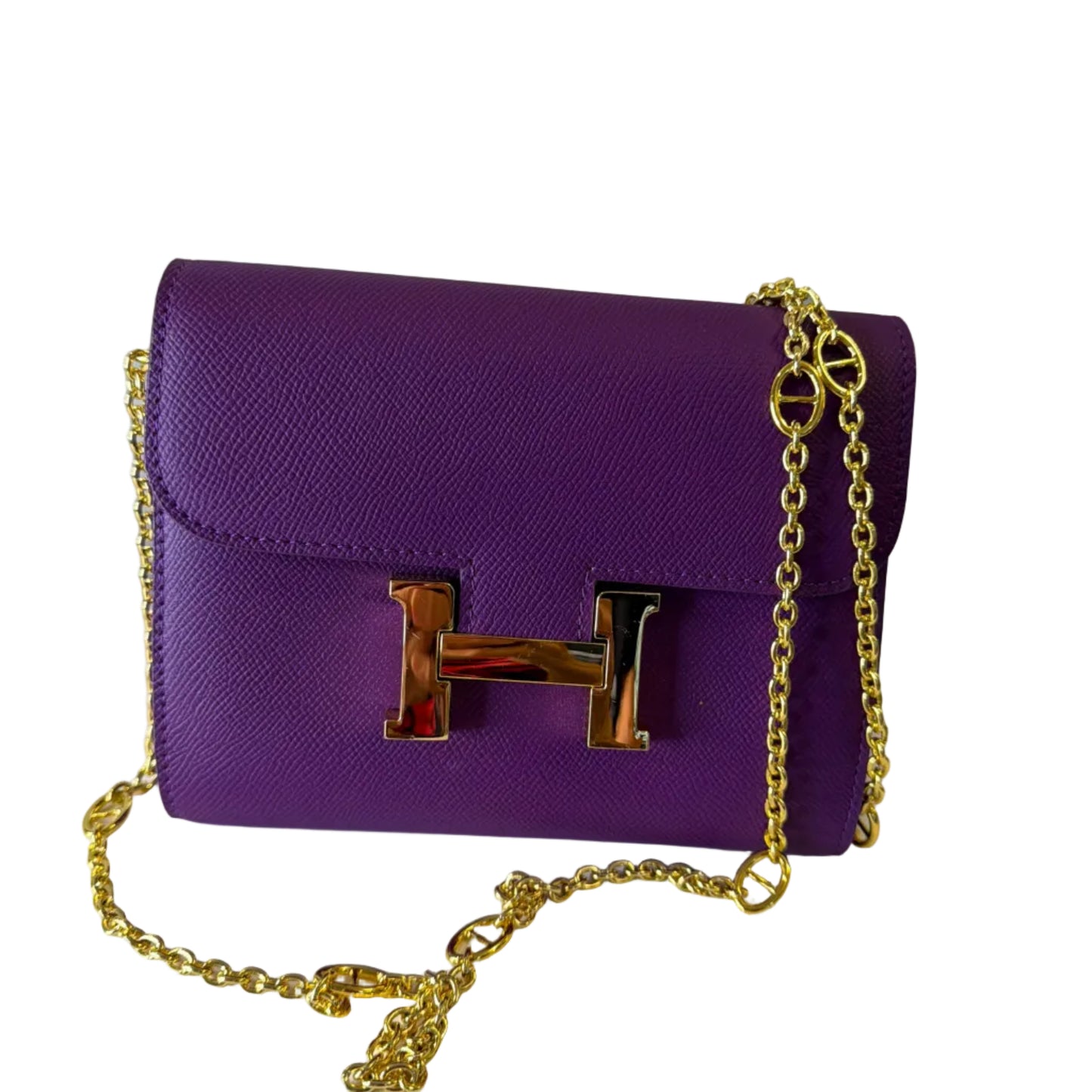 Purple handbag with gold chain and clasp on a white background