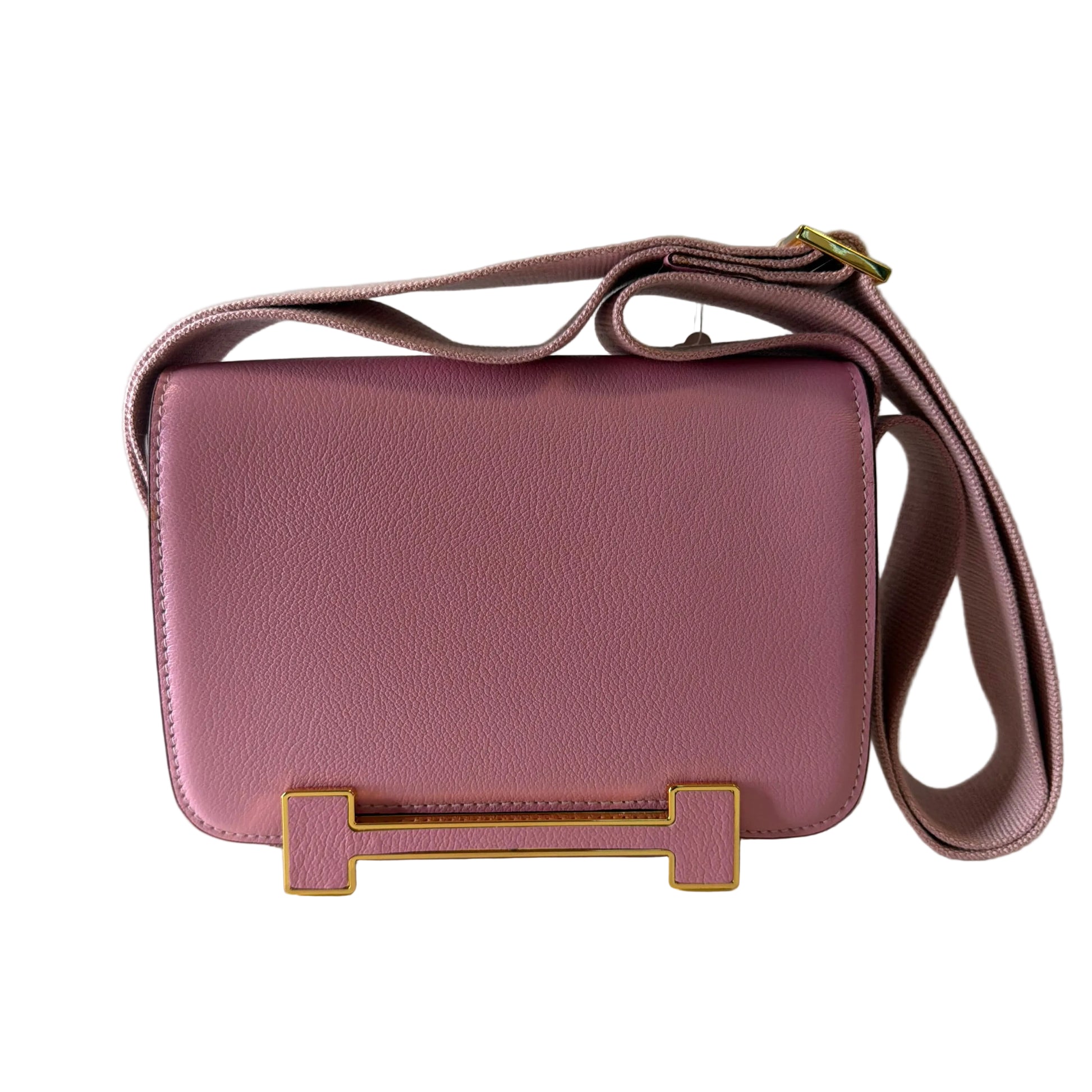 Pink handbag with gold accents on a light gray background