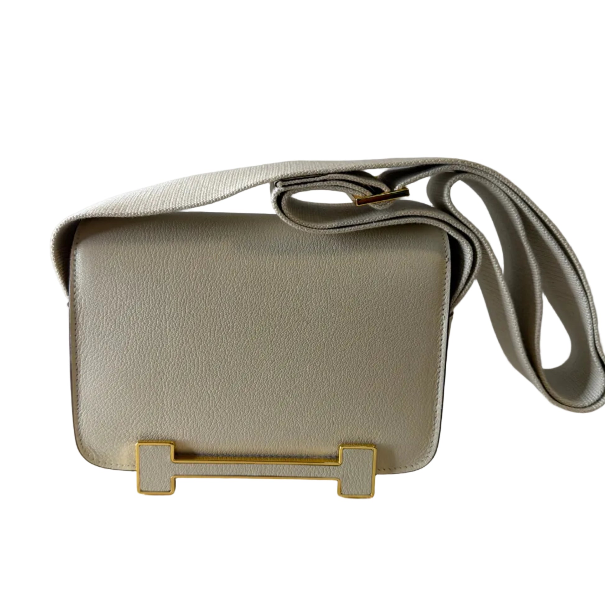 Beige handbag with a gold clasp on a light gray background