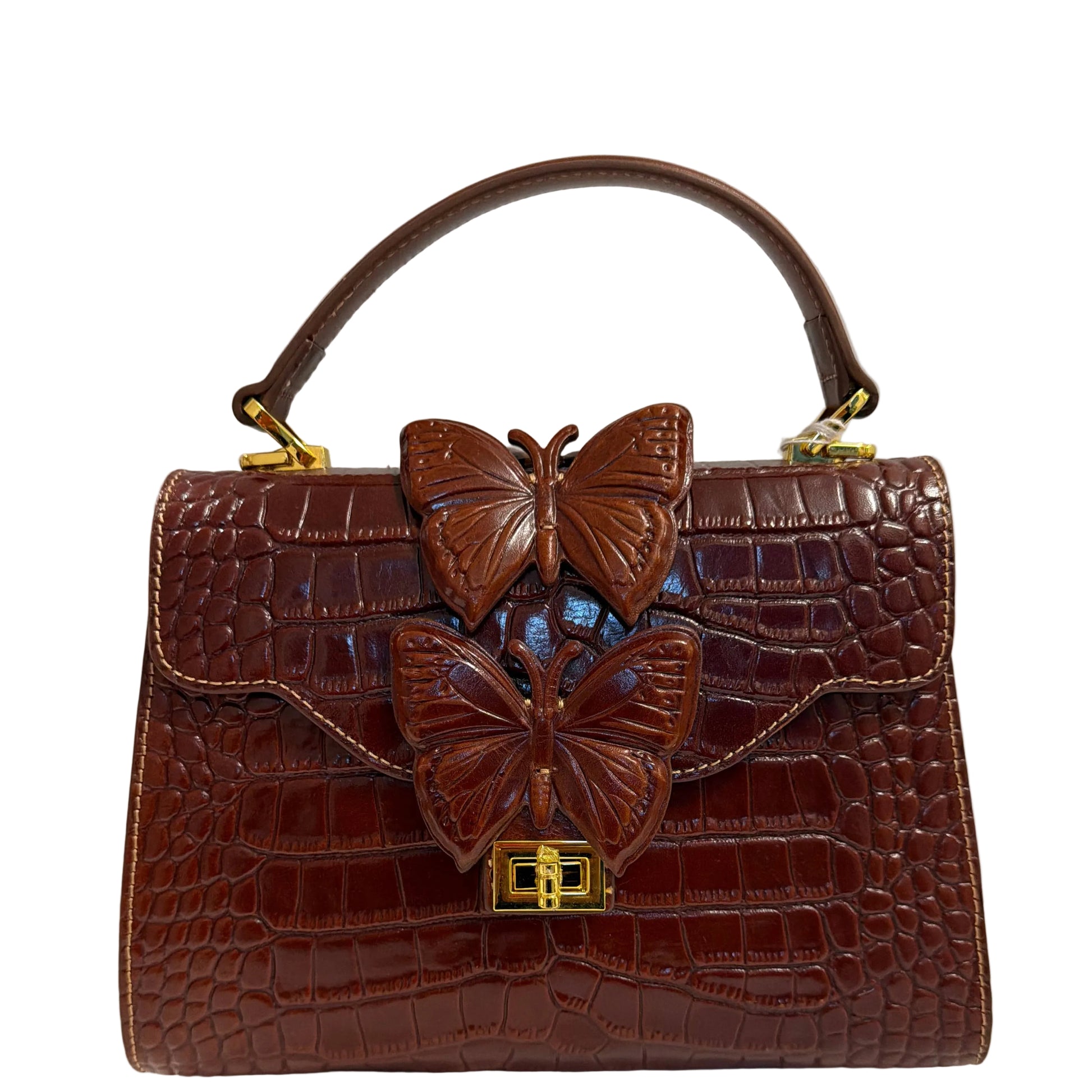 Brown leather handbag with butterfly decorations on a light gray background