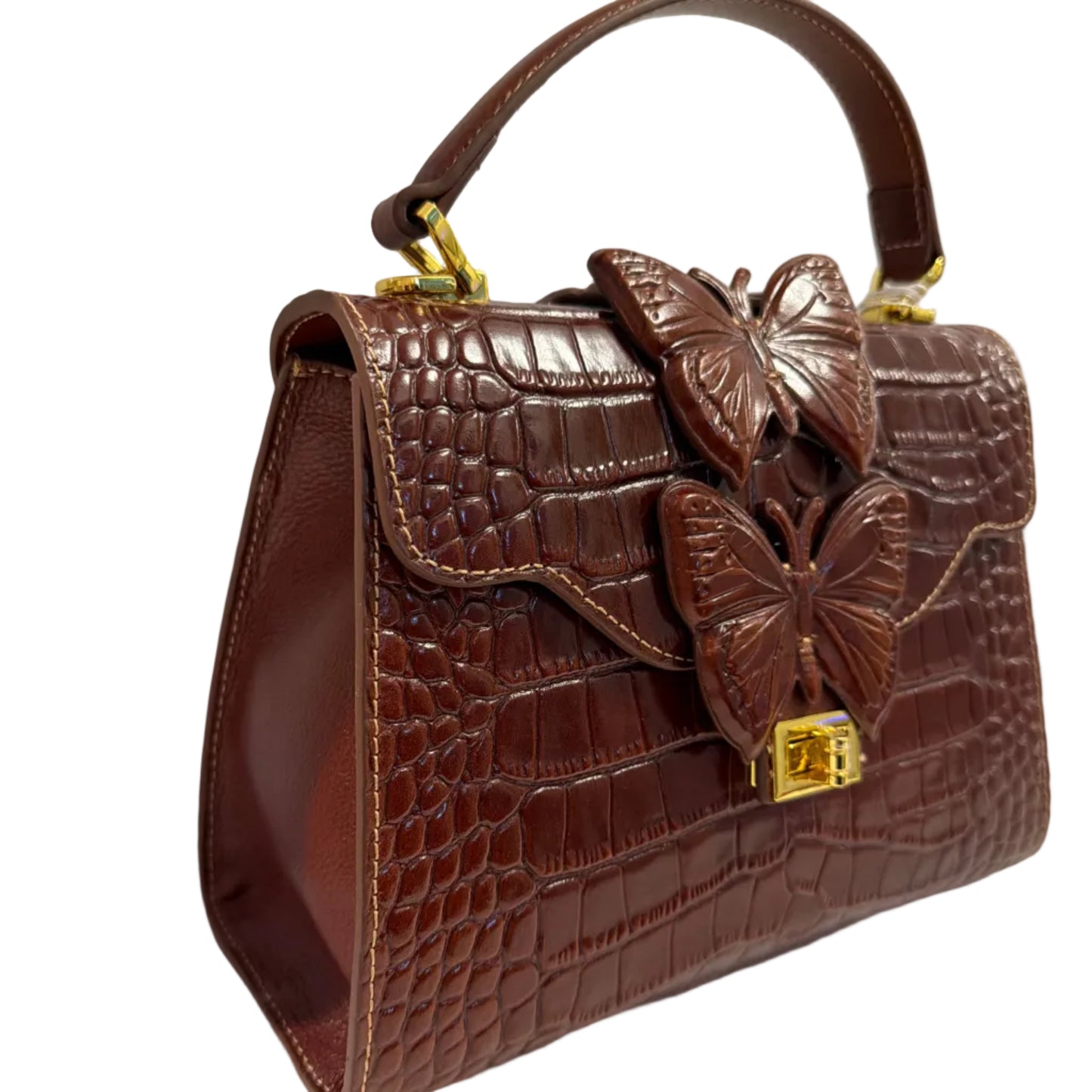 Brown leather handbag with floral details on a white background
