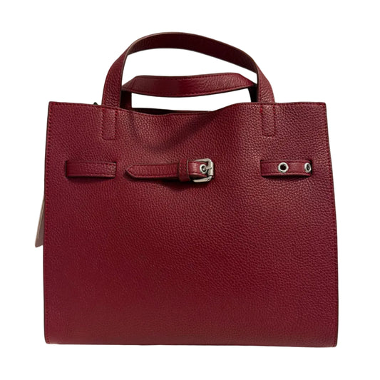Red leather handbag on a light beige background