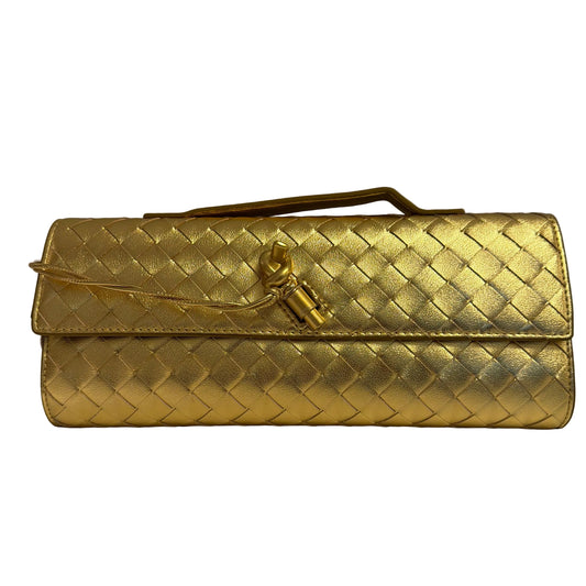 Gold woven clutch bag on a light gray background