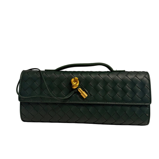Green quilted handbag with a gold clasp on a light gray background