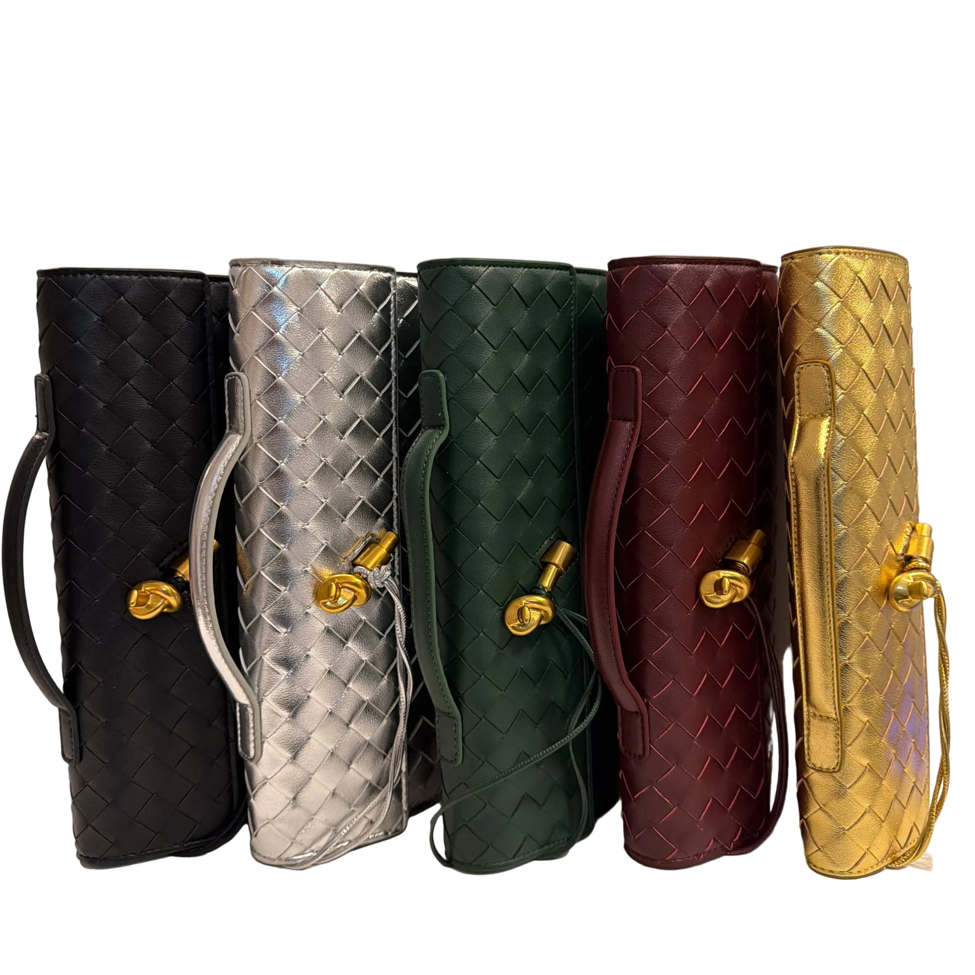 Stack of handbags in gold, red, green, silver, and black on a white surface.