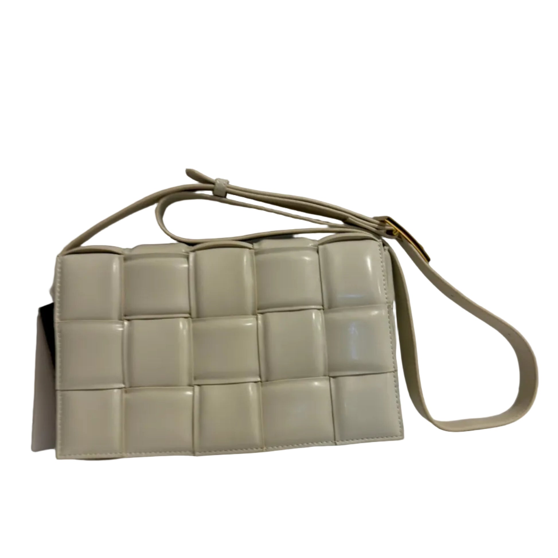 Beige woven handbag on a light gray background