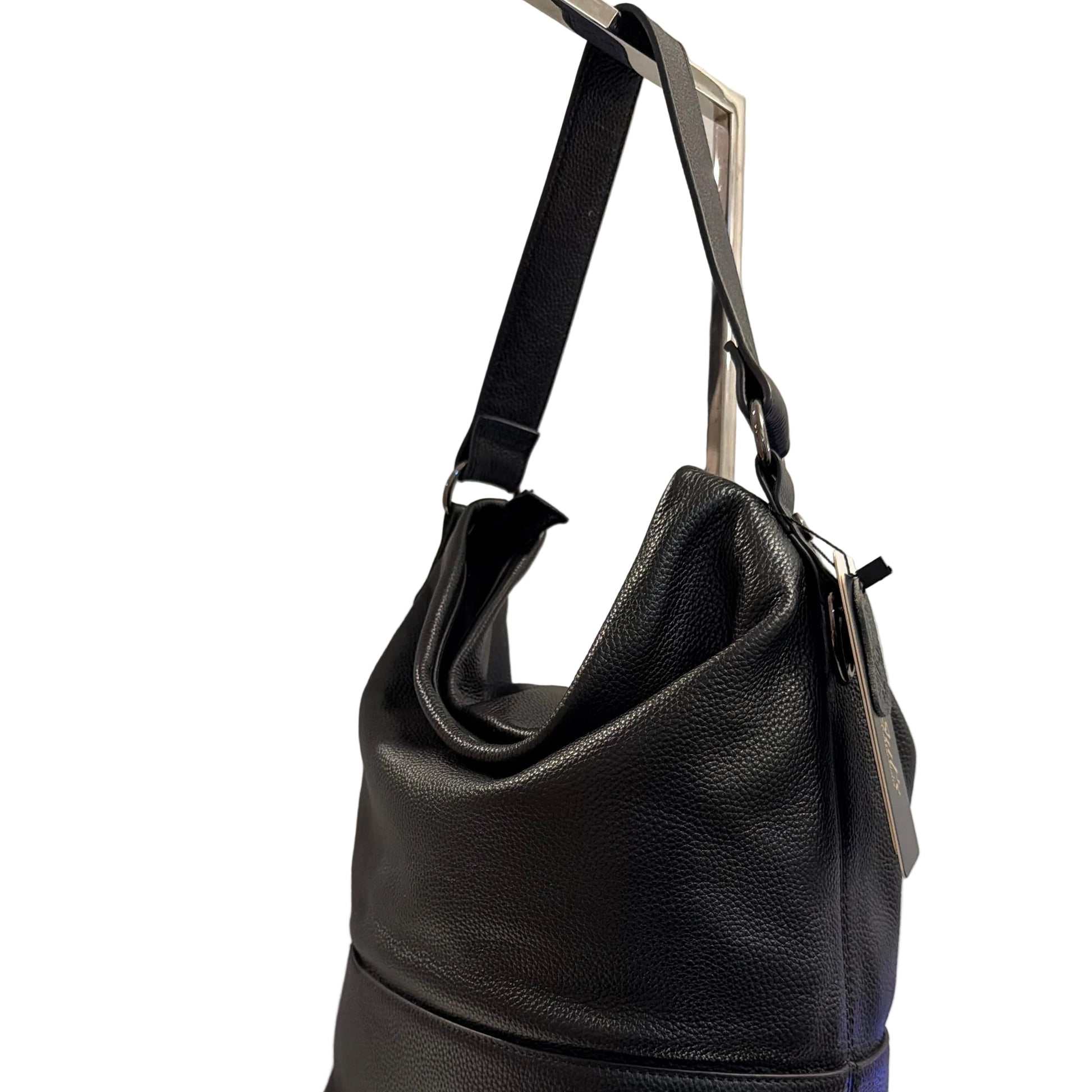 Black leather handbag on a white surface