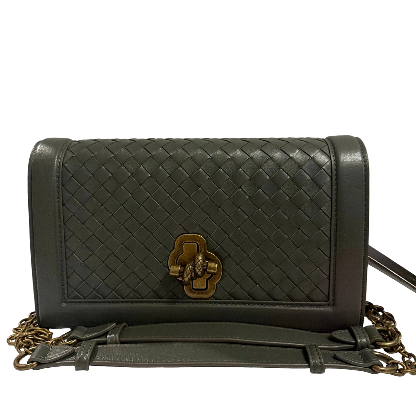 Black woven handbag with gold clasp on a white background