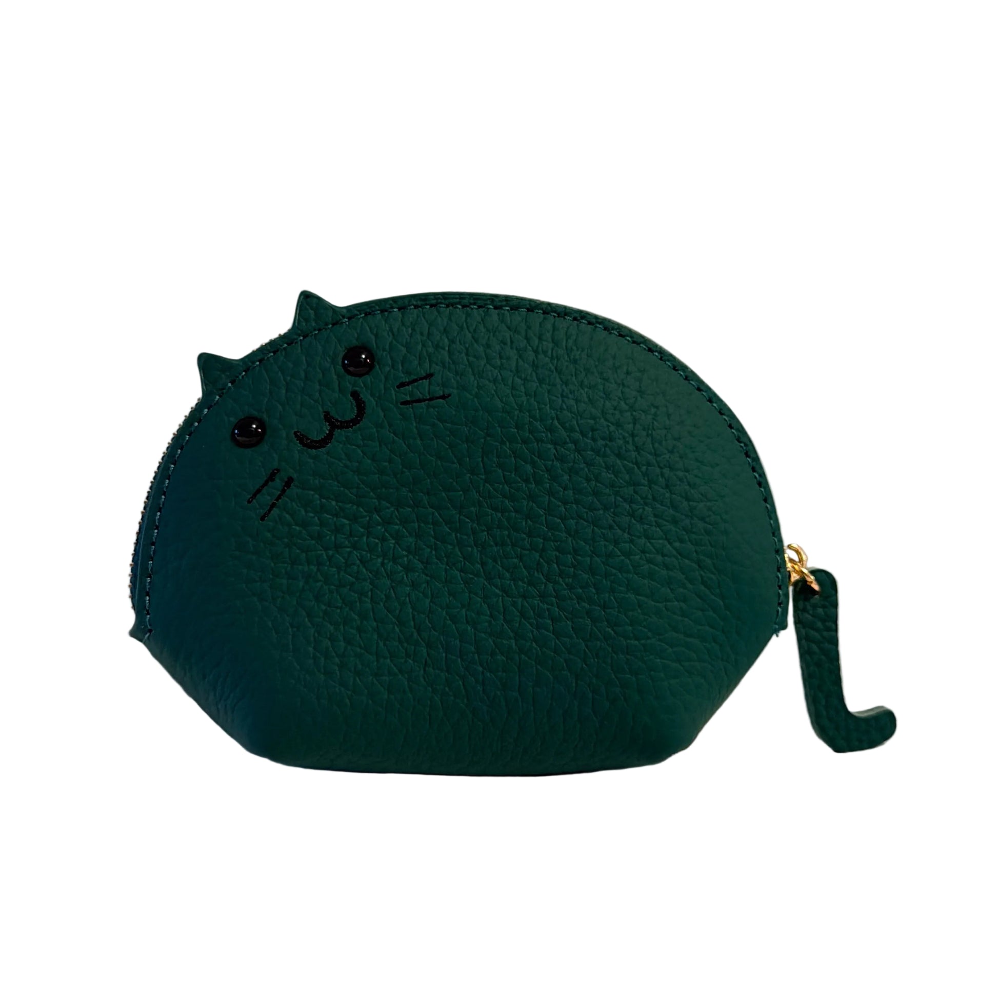 Green cat-shaped coin purse on a beige surface with a neutral background