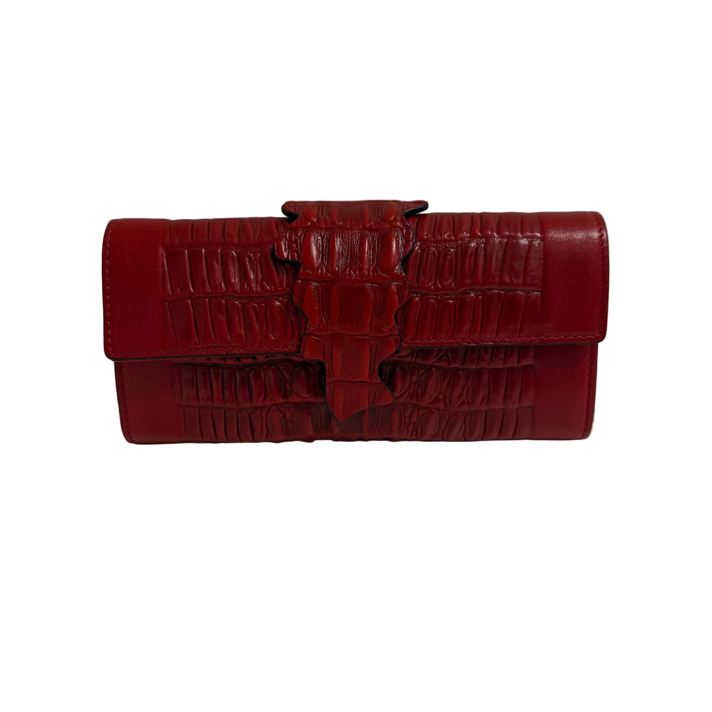 Red crocodile-patterned handbag on a white surface with a gray background