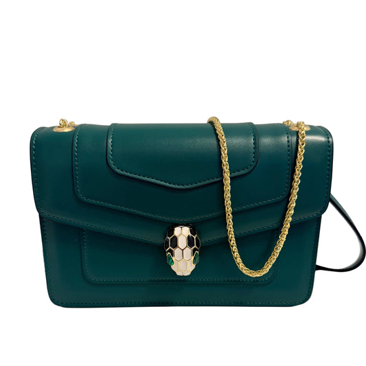 A dark teal leather shoulder bag with a gold chain strap and a silver-and-black snake head clasp, shown hanging against a plain light background.