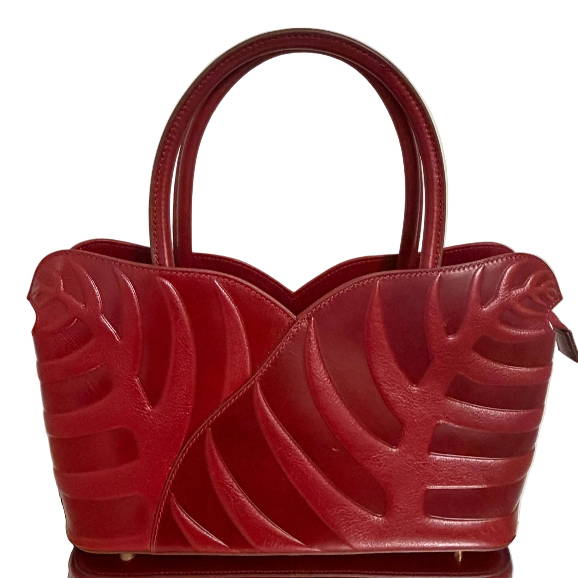 Red textured handbag on a light background