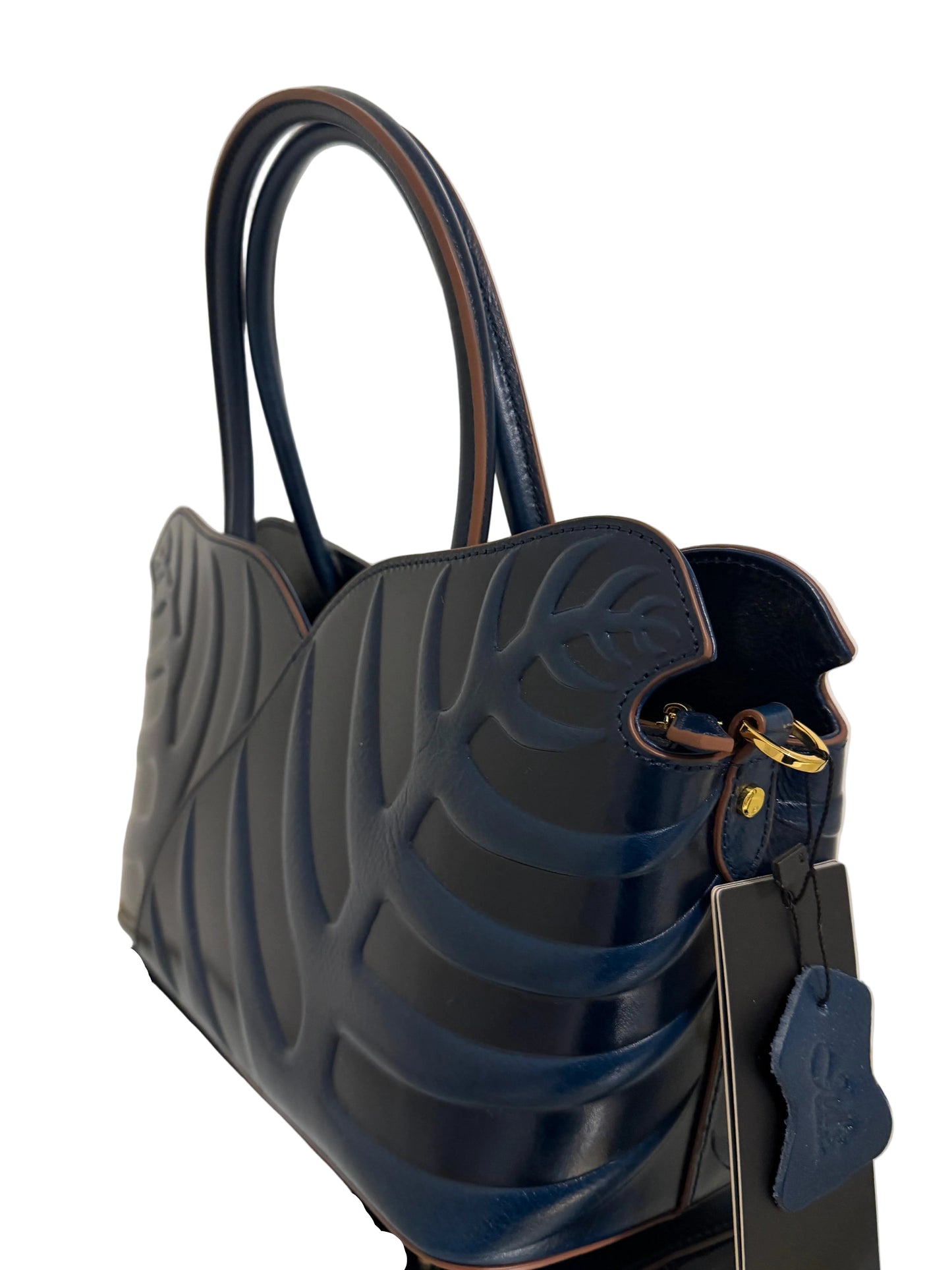 Navy blue handbag with textured surface and gold accents on a light background