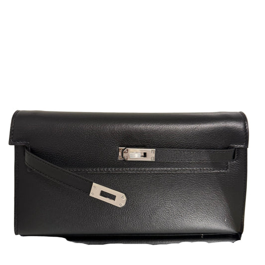 Black leather briefcase with a silver clasp on a light beige background
