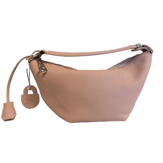 A light pink pebbled leather crescent-shaped shoulder bag with silver-tone hardware, shown next to its black presentation box and matching pink hangtag on a white surface against a light gray wall.
