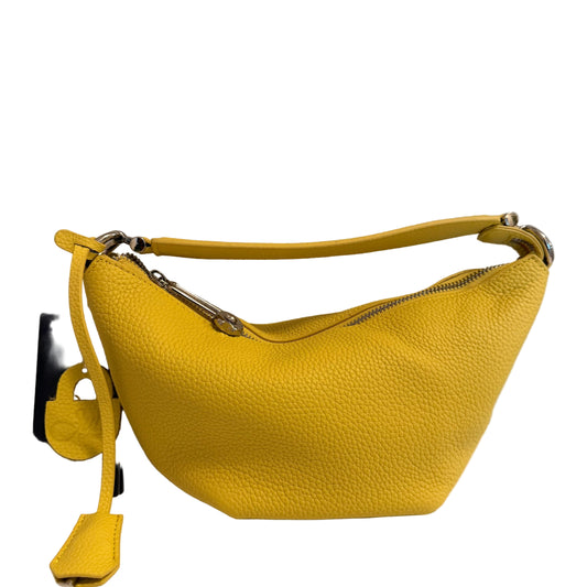 A bright yellow pebbled leather shoulder bag with a curved top handle, silver-tone hardware, and a matching yellow leather tag attached to a black card, photographed against a plain light background.
