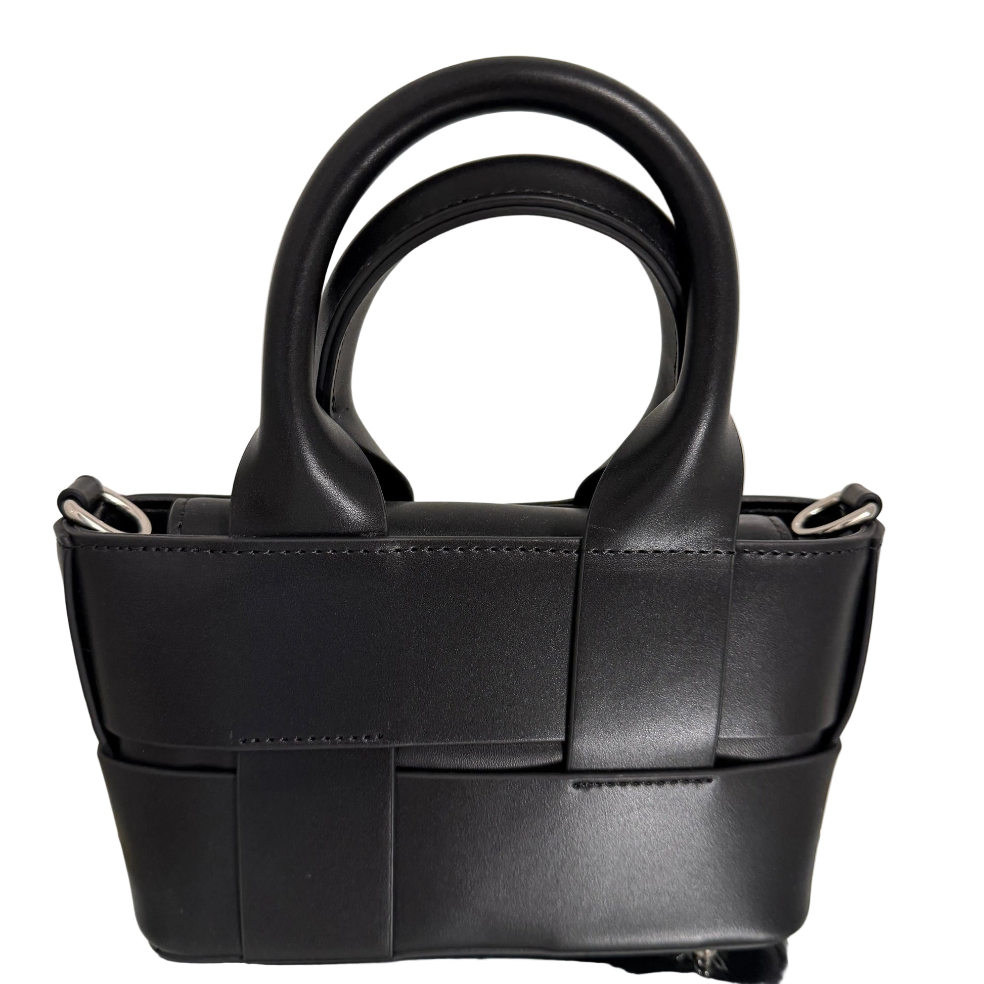 Black leather handbag with a unique handle design on a light background