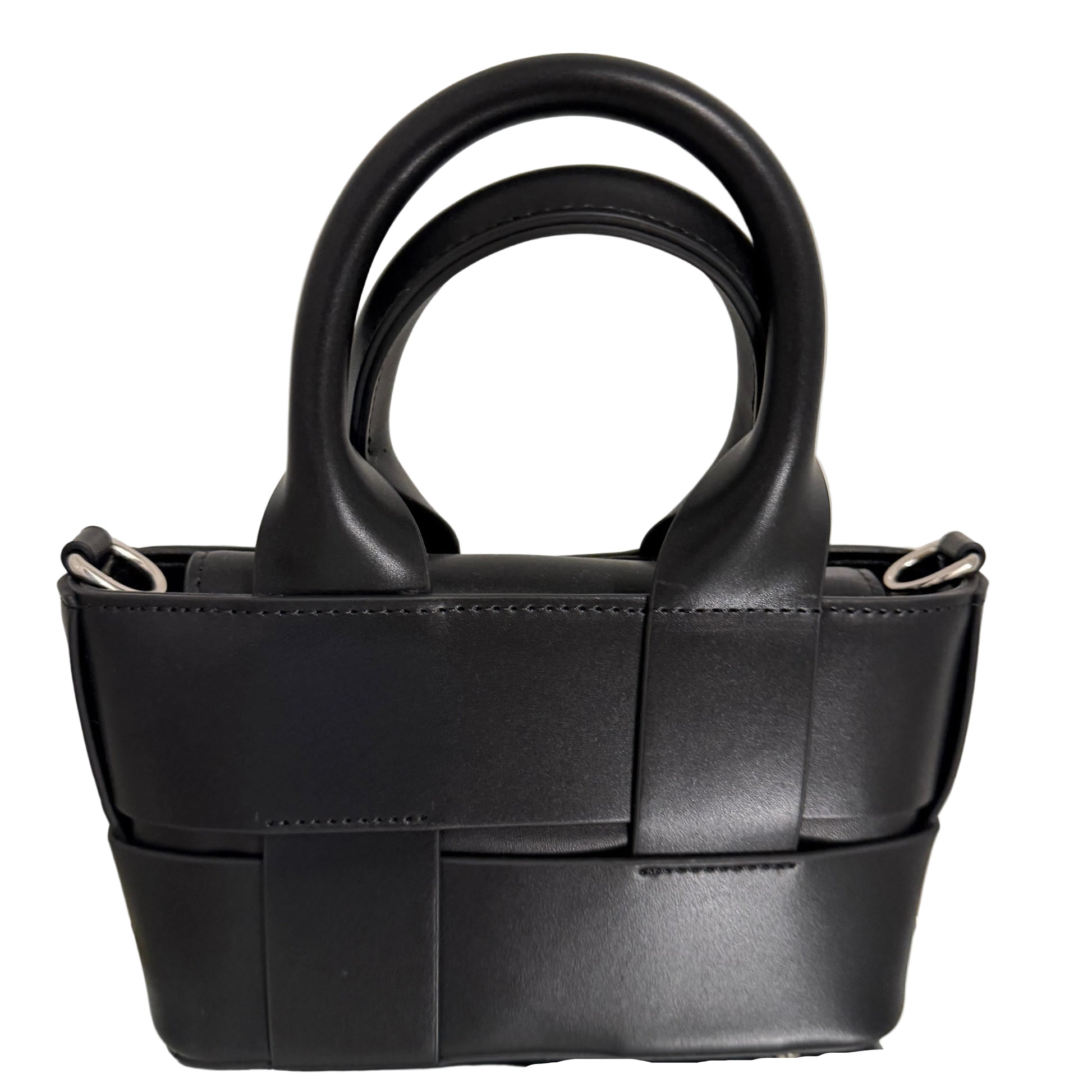 Black leather handbag with a unique design on a light beige background
