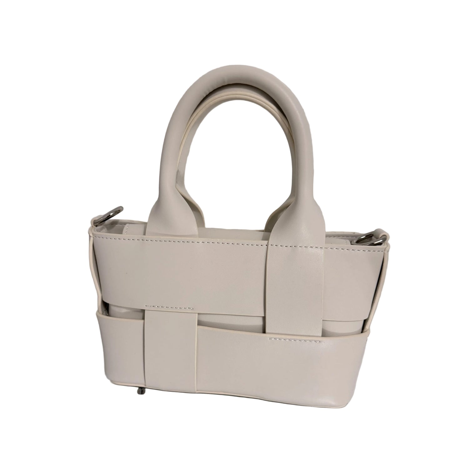 White woven handbag on a reflective surface with a light gray background