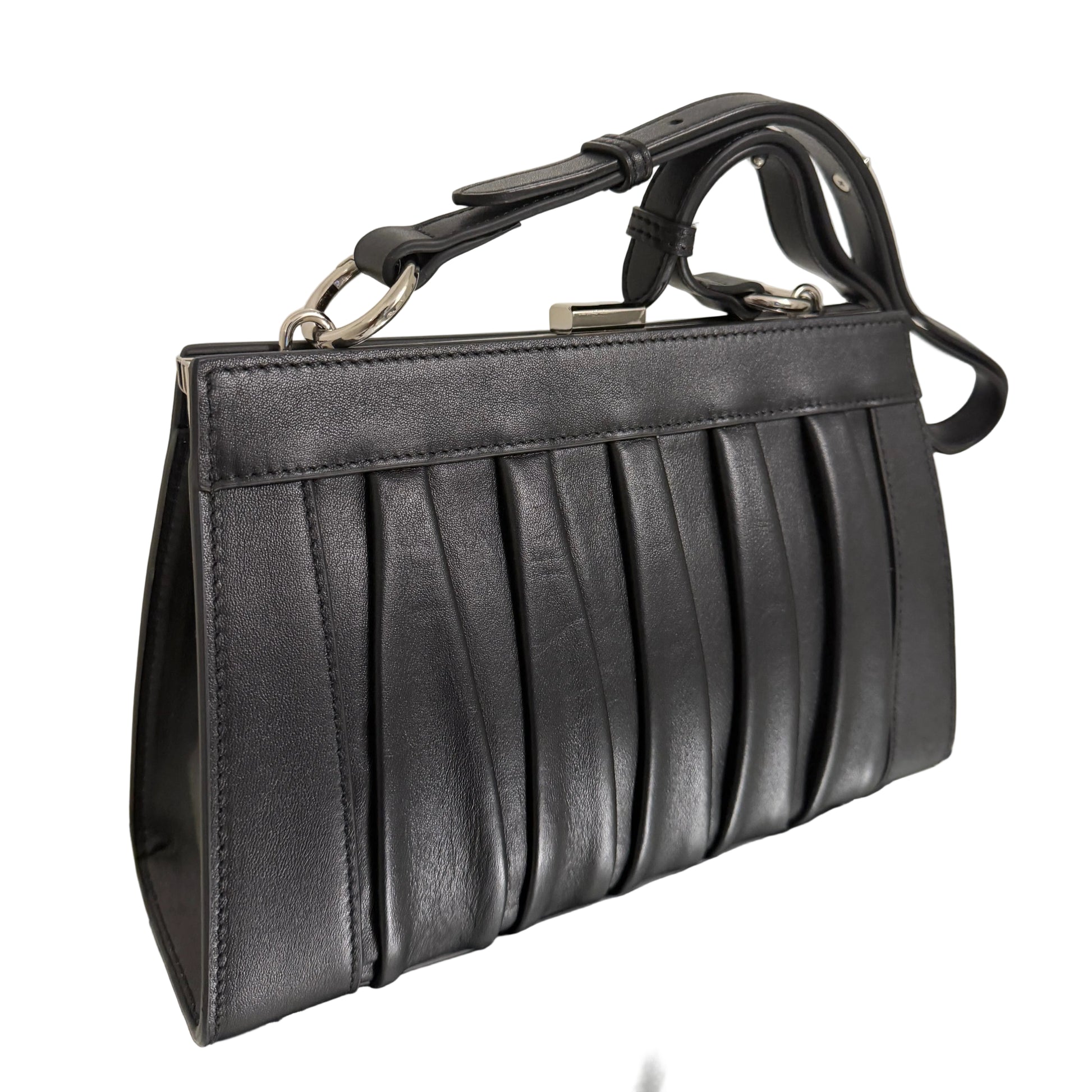 Black leather handbag on a light-colored surface
