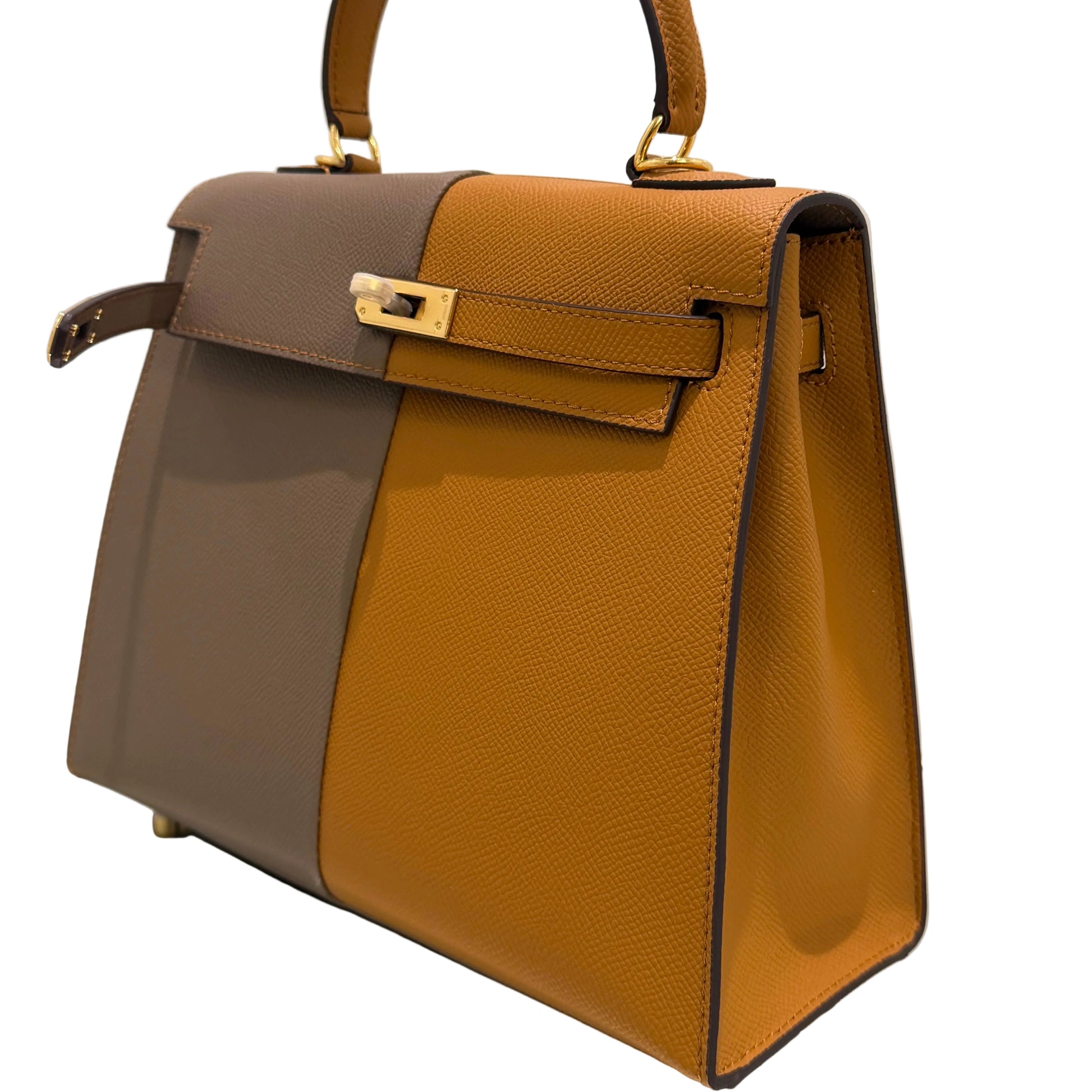 Brown and gray handbag with gold accents on a light beige background