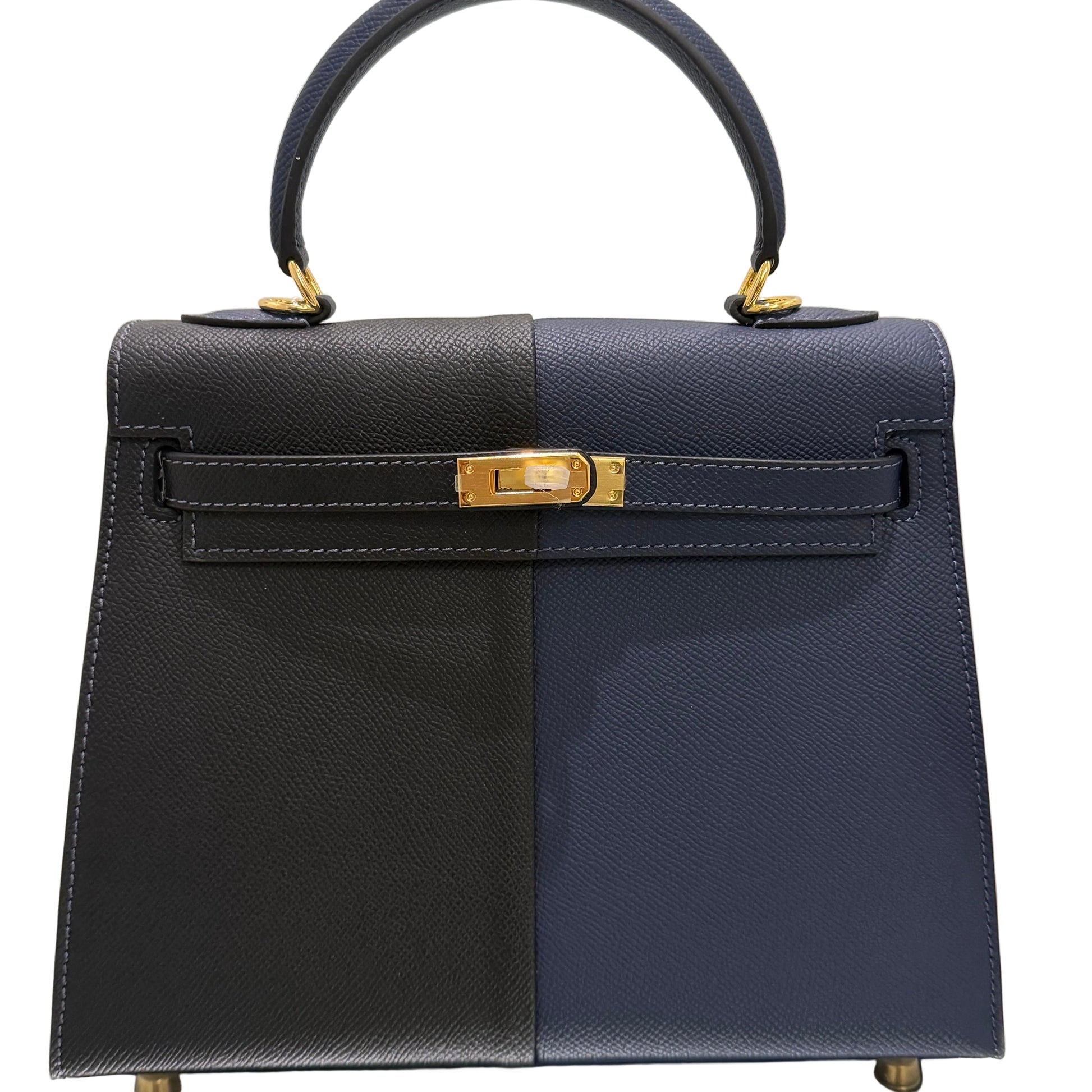 Navy and black handbag with gold accents on a light beige background