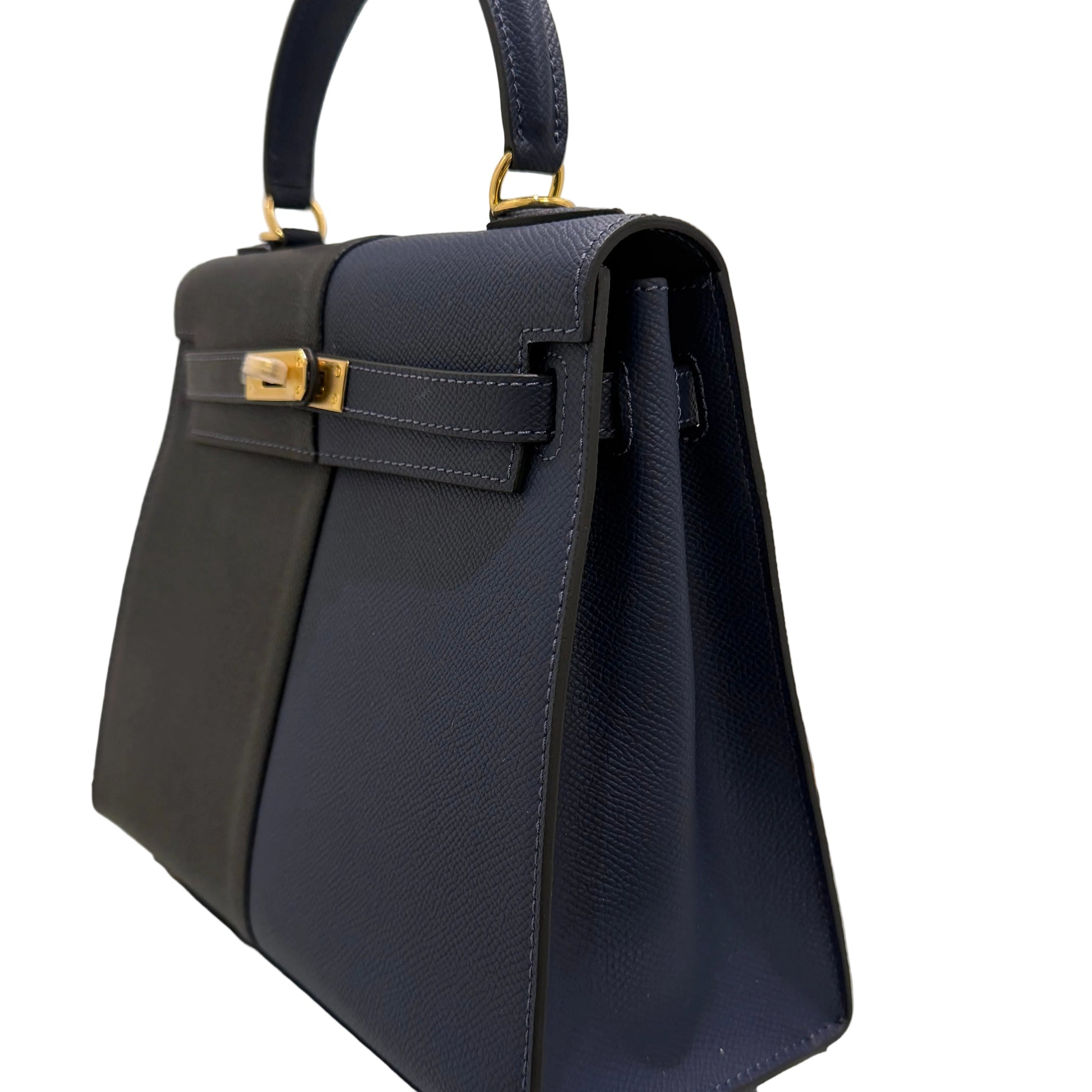 Navy blue handbag with gold accents on a light gray background