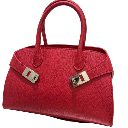 Red handbag with silver hardware on a light background