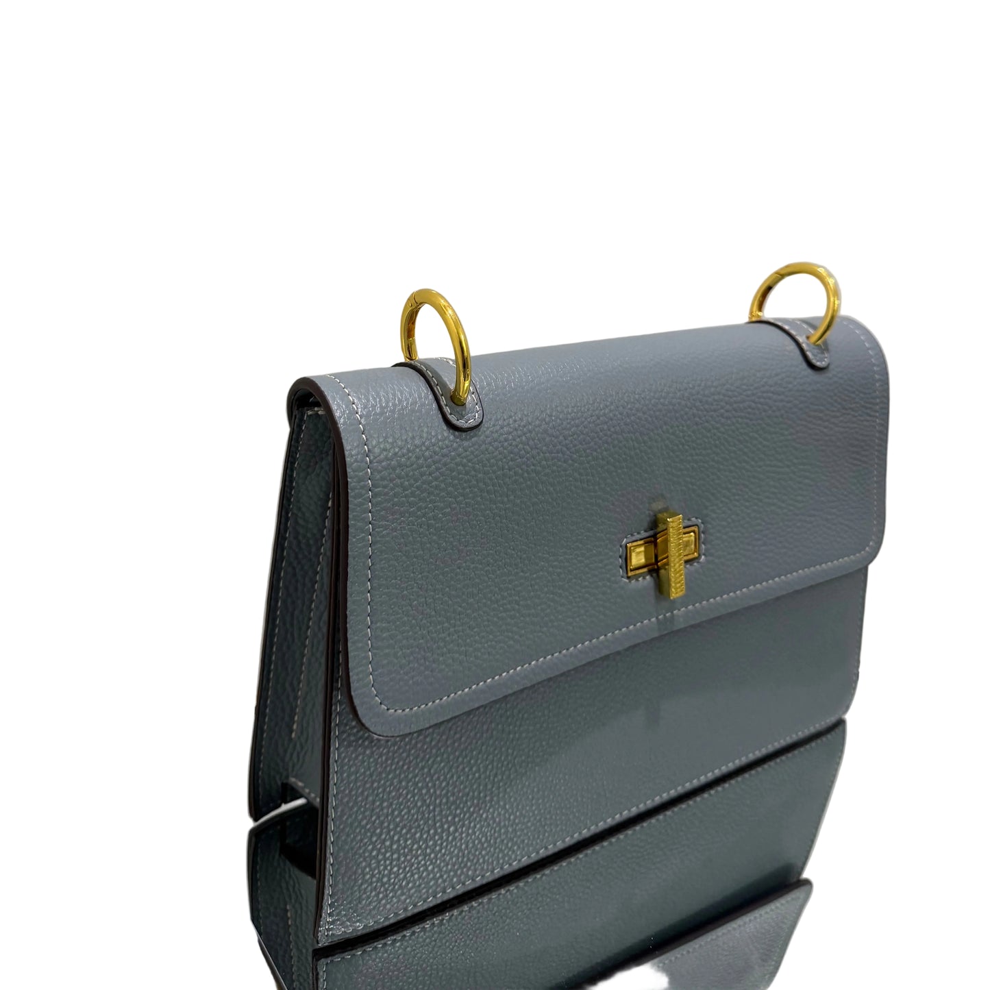 Gray leather wallet with gold accents on a light gray background