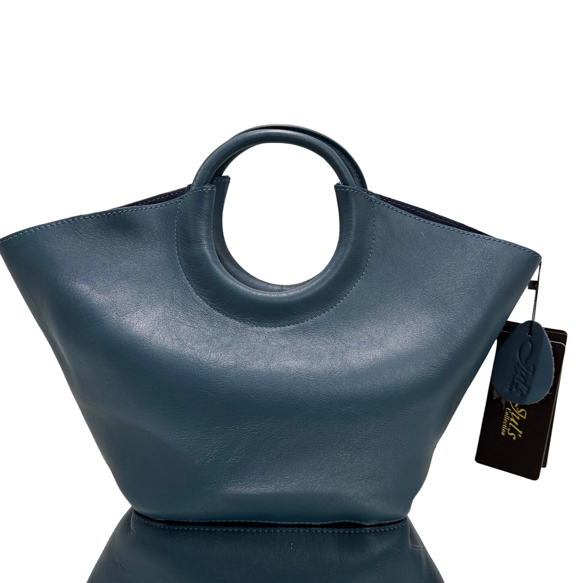 Blue handbag with a circular handle on a light background