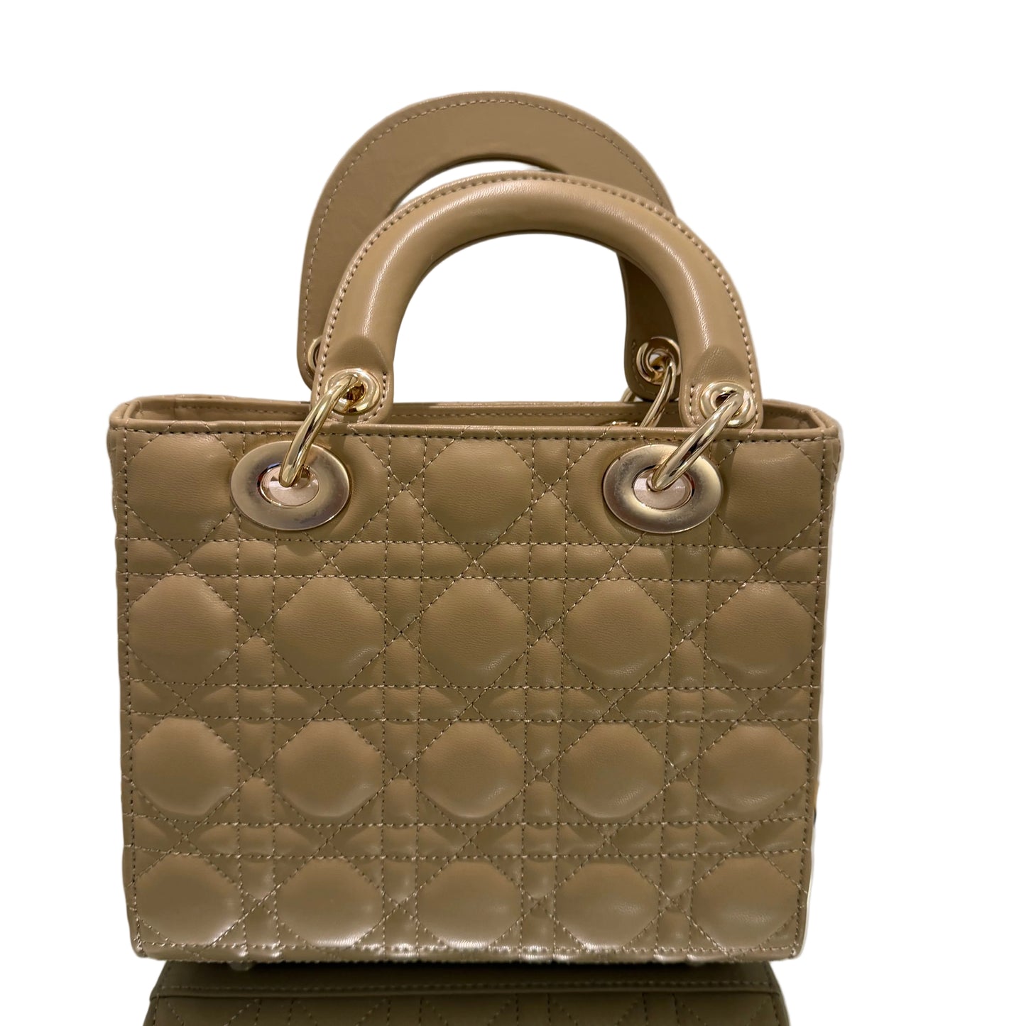 Beige quilted handbag with gold accents on a light background