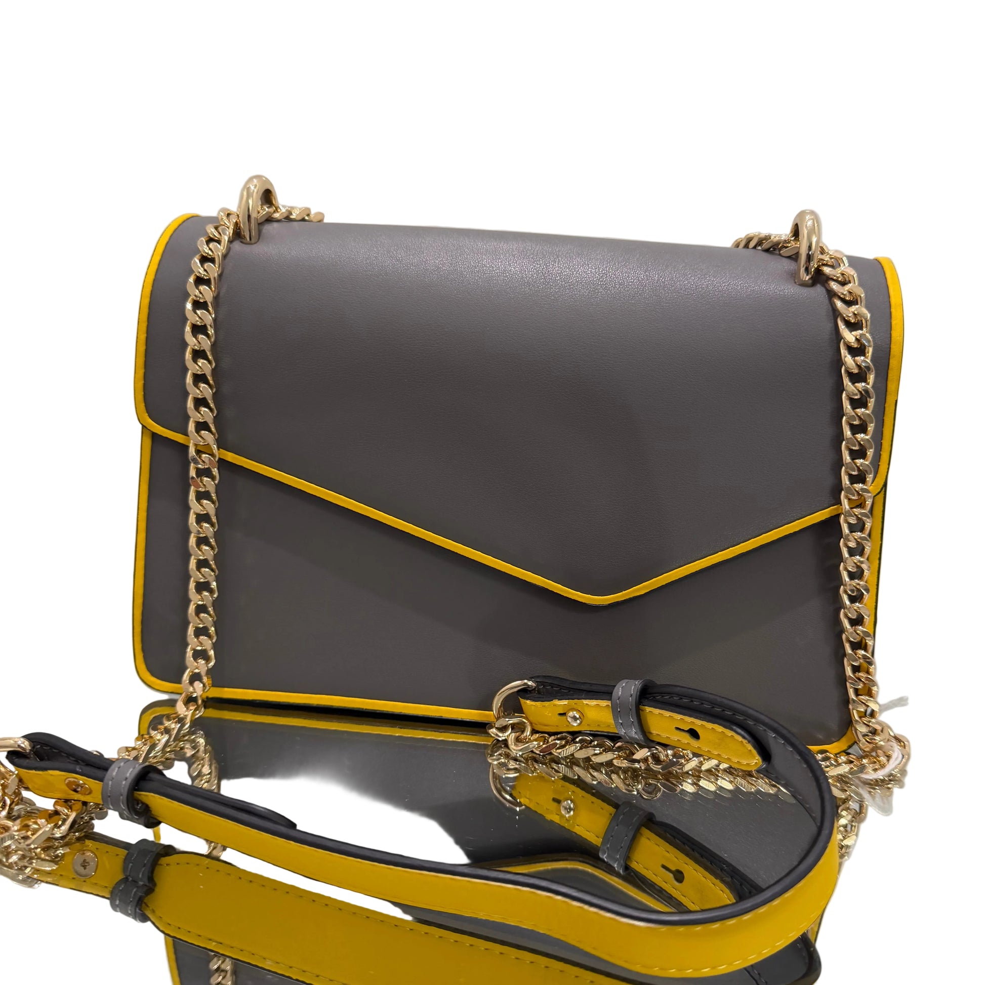 Gray and yellow handbag with gold chain detail on a light gray background