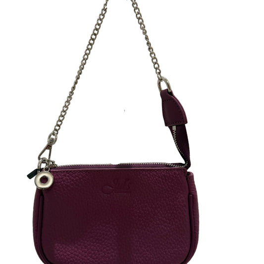 Purple handbag with a chain strap on a reflective surface
