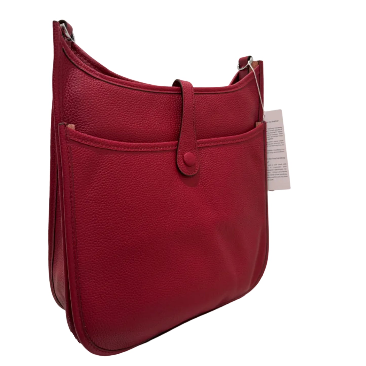 Red leather bag with a gold buckle on a white surface