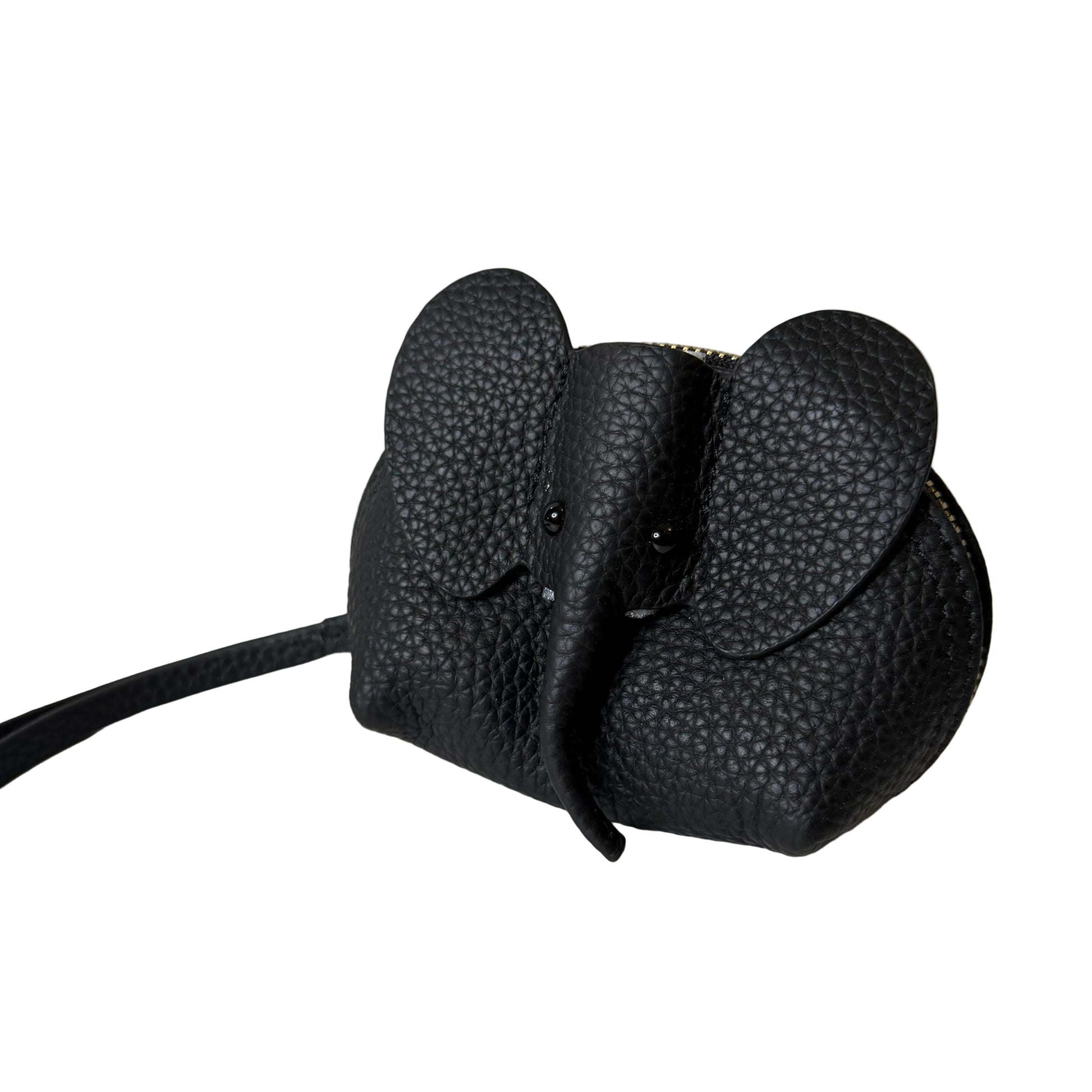Black textured object attached to a white surface